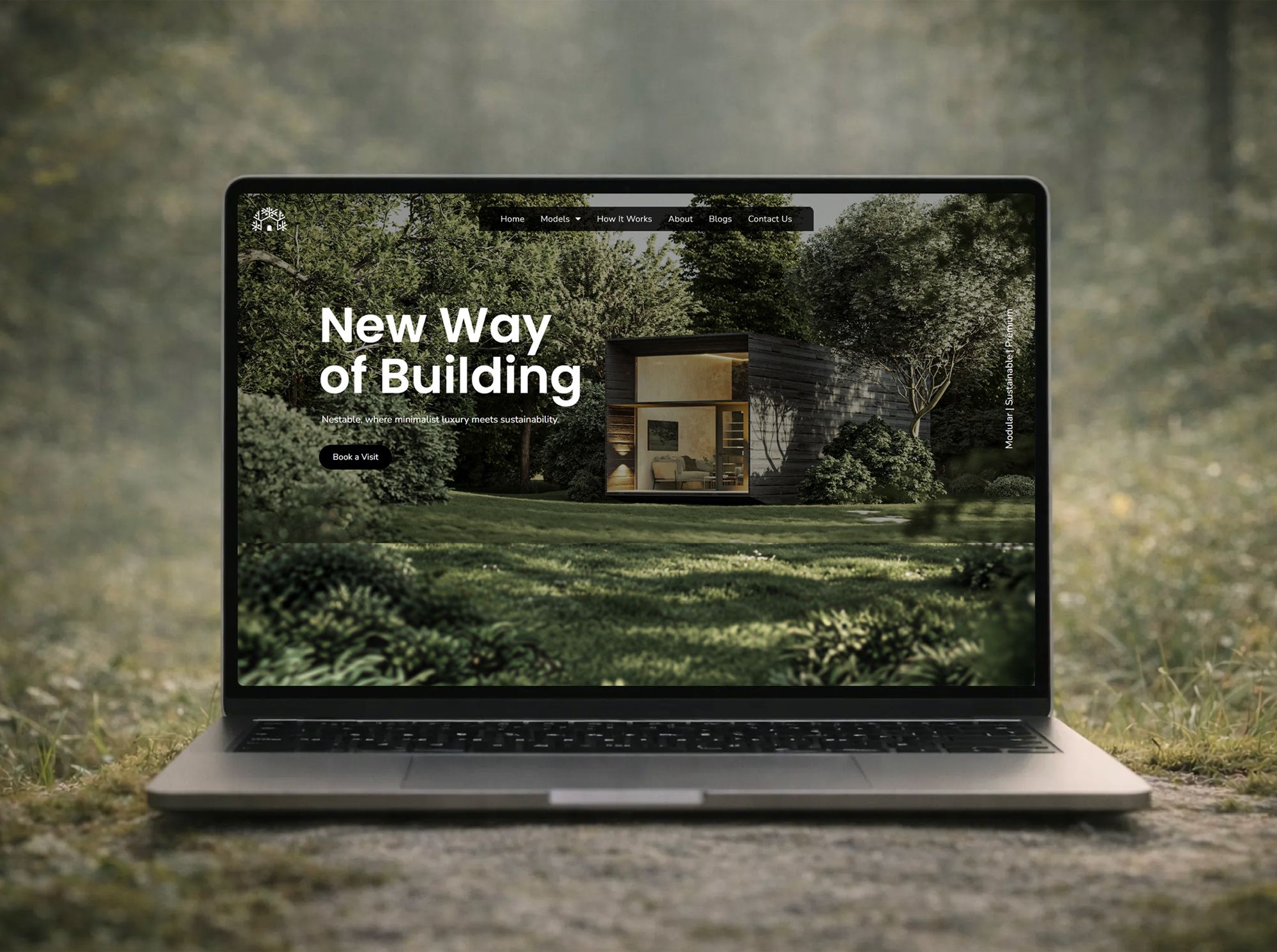 A laptop on a mossy forest floor showing the Nestable homepage, headed New Way of Building, over a photo of a timber cabin among trees.